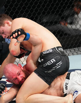 Chase Hooper (top) punches Viacheslav Borshchev of Russia in a lightweight fight during the UFC Fight Night event at Enterprise Center on May 11, 2024 in St Louis, Missouri.