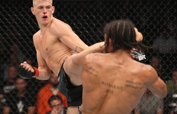  Ian Garry of Ireland kicks Darian Weeks in their welterweight fight during the UFC 273 event at VyStar Veterans Memorial Arena on April 09, 2022 in Jacksonville, Florida. (Photo by Jeff Bottari/Zuffa LLC)