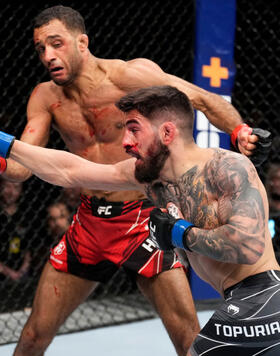 Ilia Topuria of Spain punches Jai Herbert of England in a lightweight fight during the UFC Fight Night event at O2 Arena on March 19, 2022 in London, England. (Photo by Chris Unger/Zuffa LLC)