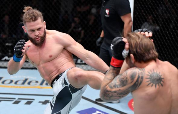 Rafael Fiziev of Kyrgyzstan kicks Brad Riddell of New Zealand in their lightweight fight during the UFC Fight Night event at UFC APEX on December 04, 2021 in Las Vegas, Nevada. (Photo by Jeff Bottari/Zuffa LLC)