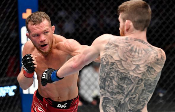 Petr Yan of Russia punches Cory Sandhagen in the UFC interim bantamweight championship fight during the UFC 267 event at Etihad Arena on October 30, 2021 in Yas Island, Abu Dhabi, United Arab Emirates. (Photo by Chris Unger/Zuffa LLC)