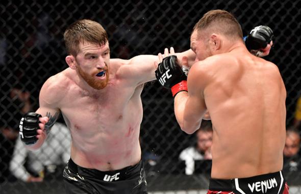 Cory Sandhagen punches Petr Yan of Russia in the UFC interim bantamweight championship fight during the UFC 267 event at Etihad Arena on October 30, 2021 in Yas Island, Abu Dhabi, United Arab Emirates. (Photo by Chris Unger/Zuffa LLC)