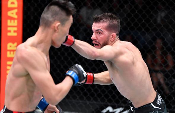 Cody Durden punches Aoriqileng of China in a flyweight fight during the UFC Fight Night event at UFC APEX on November 20, 2021 in Las Vegas, Nevada. (Photo by Chris Unger/Zuffa LLC)