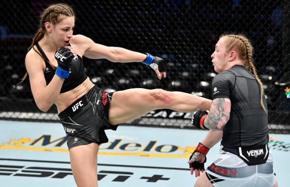 Jasmine Jasudavicius of Canada kicks Kay Hansen in their flyweight fight during the UFC 270 event at Honda Center on January 22, 2022 in Anaheim, California. (Photo by Chris Unger/Zuffa LLC)