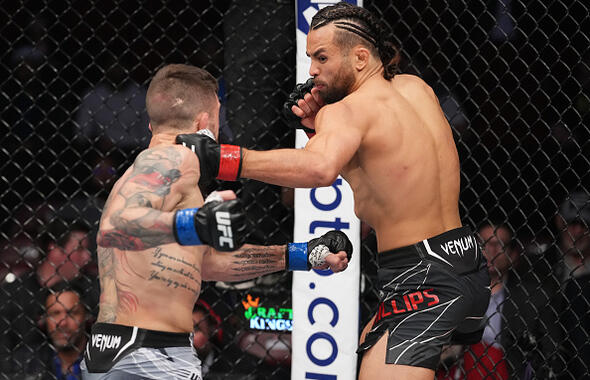 Kyler Phillips punches Marcelo Rojo of Mexico in their bantamweight fight during the UFC 271 event at Toyota Center on February 12, 2022 in Houston, Texas. (Photo by Josh Hedges/Zuffa LLC)