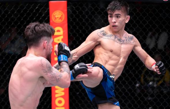  Mario Bautista kicks Jay Perrin in their bantamweight fight during the UFC Fight Night event at UFC APEX on February 19, 2022 in Las Vegas, Nevada. (Photo by Jeff Bottari/Zuffa LLC)