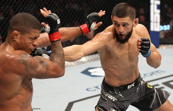 Khamzat Chimaev of Russia punches Gilbert Burns of Brazil in their welterweight fight during the UFC 273 event at VyStar Veterans Memorial Arena on April 09, 2022 in Jacksonville, Florida. (Photo by Jeff Bottari/Zuffa LLC)