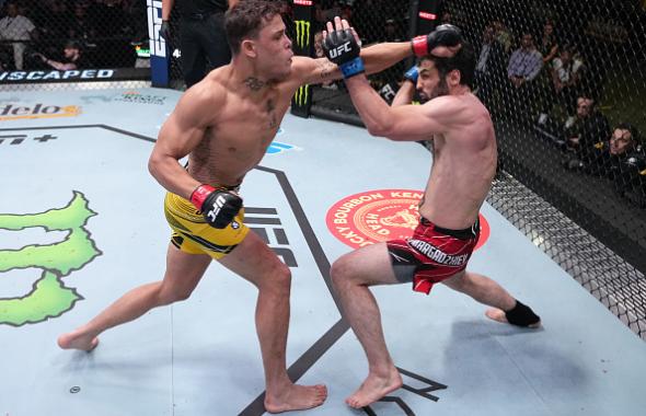 Caio Borralho of Brazil punches Gadzhi Omargadzhiev of Russia in a middleweight fight during the UFC Fight Night event at UFC APEX on April 16, 2022 in Las Vegas, Nevada. (Photo by Jeff Bottari/Zuffa LLC)