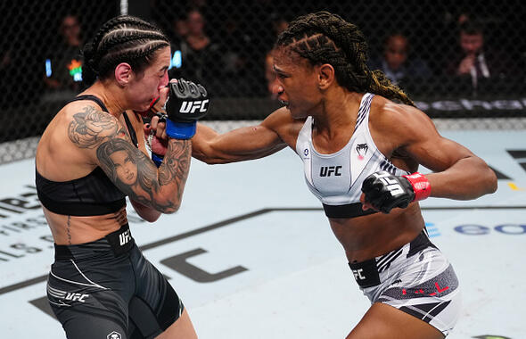 Angela Hill punches Emily Ducote in a strawweight fight during the UFC Fight Night event at Amway Center on December 03, 2022 in Orlando, Florida. (Photo by Jeff Bottari/Zuffa LLC)