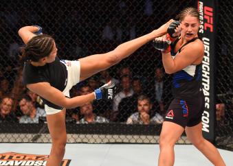 HOUSTON, TX - OCTOBER 03:  (L-R) Julianna Pena kicks Jessica Eye in their women's bantamweight bout during the UFC 192 event at the Toyota Center on October 3, 2015 in Houston, Texas. (Photo by Josh Hedges/Zuffa LLC via Getty Images)